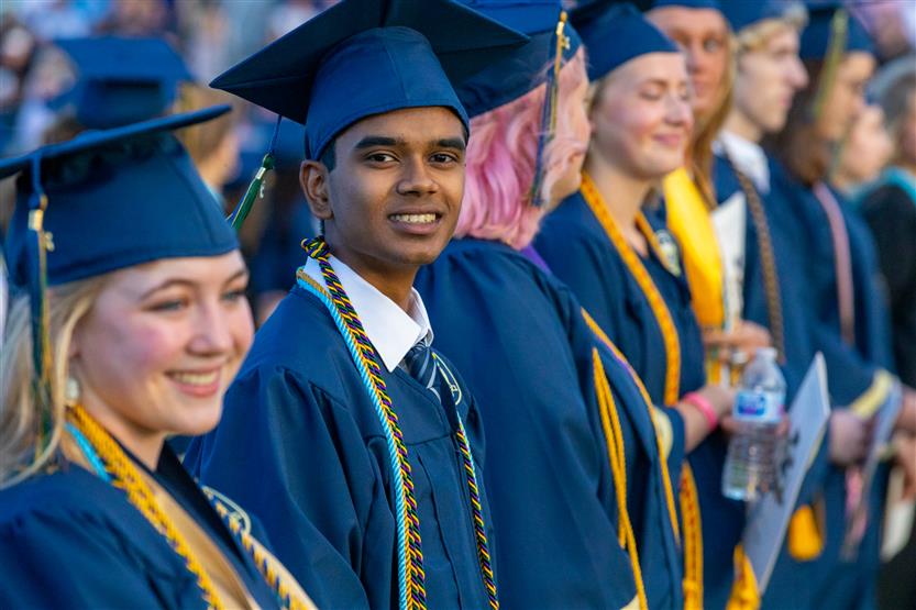 Students wearing blue graduation robes